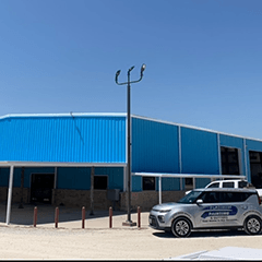 a painted blue building with cars parked nearby