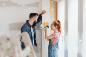 a young couple repainting the inside of their home