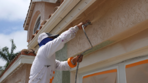 a professional painter repainting a home’s exterior